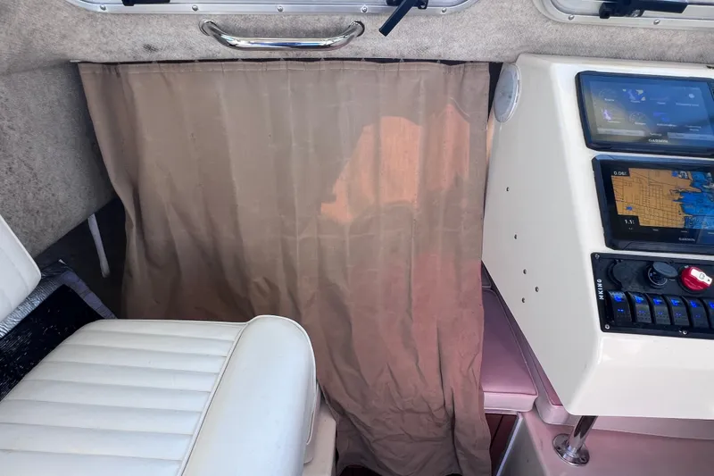 Slide: The Image of Interior of a 2012 Parker 2320 SL Sport Cabin with navigation equipment and seating. - 35