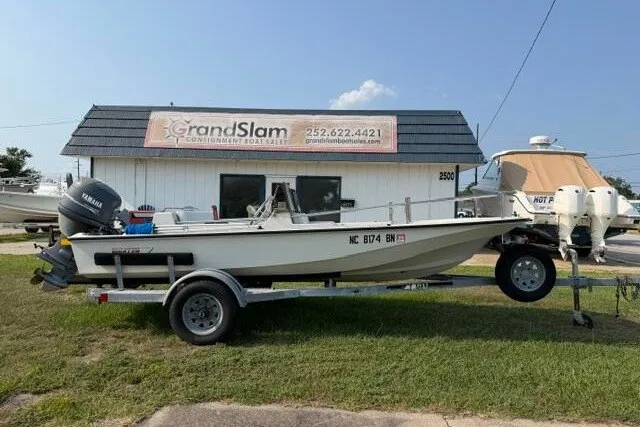 The Image of 1988 Boston Whaler 150 Super Sport boat on trailer outside Grand Slam dealership. - 1
