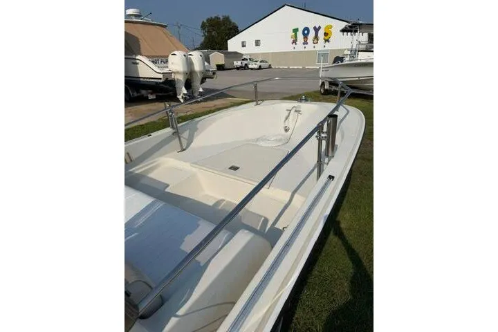 Slide: The Image of 1988 Boston Whaler 150 Super Sport boat on display outdoors. - 17