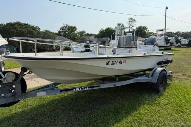 Slide: The Image of 1988 Boston Whaler 150 Super Sport boat on trailer, parked on grass. - 4