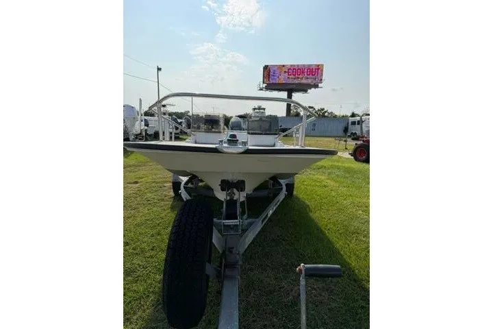 Slide: The Image of 1988 Boston Whaler 150 Super Sport boat on trailer, parked on grass under a clear sky. - 3