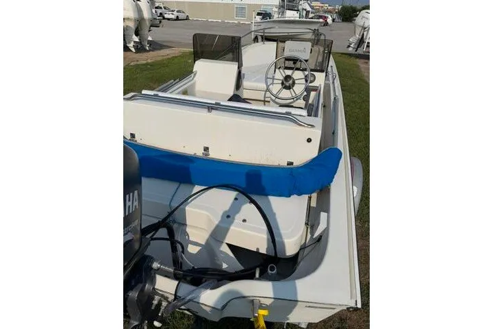 Slide: The Image of 1988 Boston Whaler 150 Super Sport boat with Yamaha engine, docked on grass. - 14