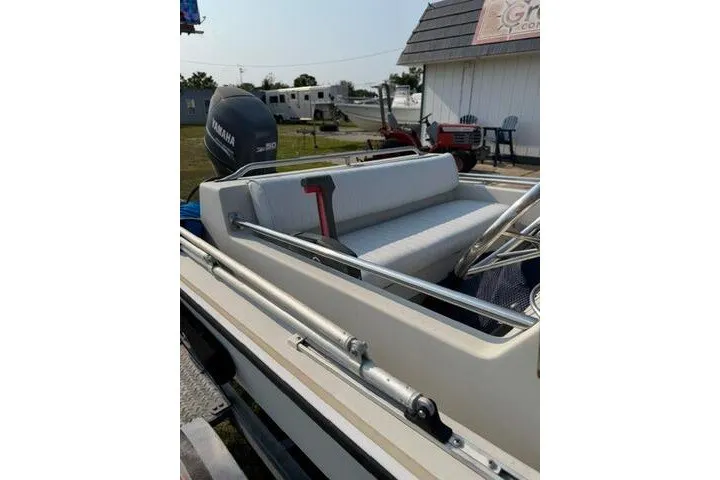 Slide: The Image of 1988 Boston Whaler 150 Super Sport boat with Yamaha outboard motor, parked outdoors. - 19