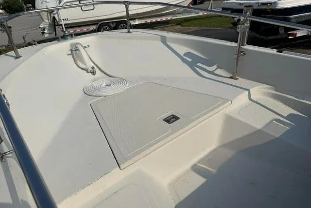 Slide: The Image of 1988 Boston Whaler 150 Super Sport boat deck with storage hatch and railing. - 5
