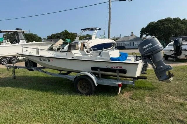 Slide: The Image of 1988 Boston Whaler 150 Super Sport boat on trailer with Yamaha outboard motor. - 10