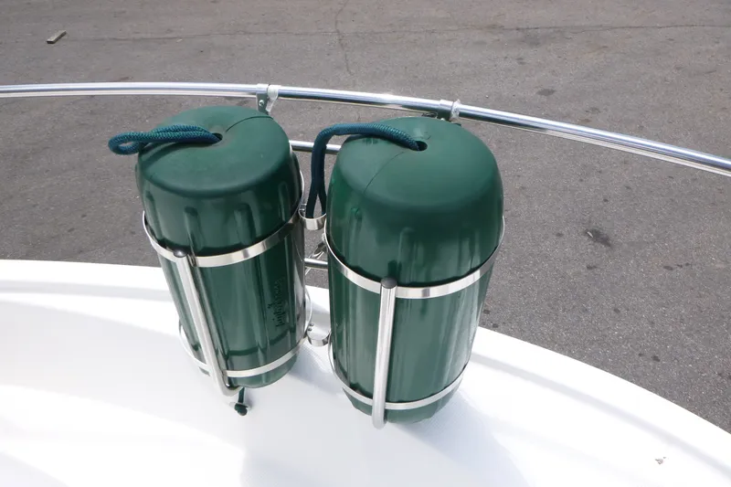 Slide: The Image of Green fenders on a 2010 Trophy 2152 Walkaround boat, secured with metal brackets. - 7