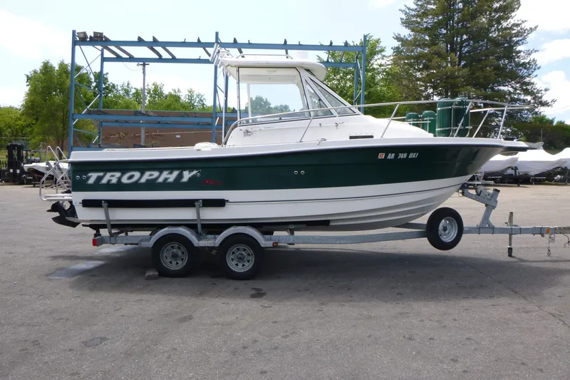 The Image of 2010 Trophy 2152 Walkaround boat on trailer in outdoor setting. - 1