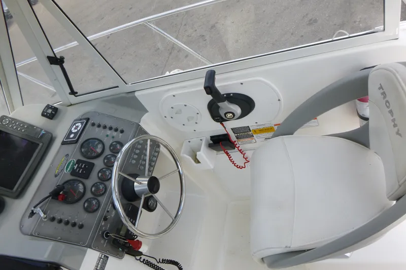 Slide: The Image of 2010 Trophy 2152 Walkaround boat cockpit with steering wheel and control panel. - 9
