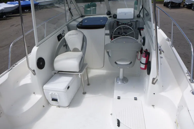 Slide: The Image of 2010 Trophy 2152 Walkaround boat interior with steering wheel, seats, and control panel. - 5