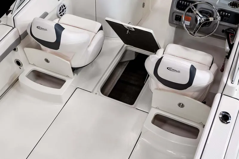 Slide: The Image of Manufacturer Provided Image: 2025 Robalo R207 Dual Console interior with white seating and storage compartments. - 10