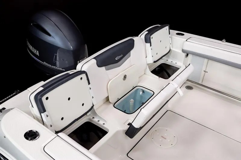 Slide: The Image of Manufacturer Provided Image: 2025 Robalo R207 Dual Console boat interior with Yamaha engine, featuring seating and storage. - 12