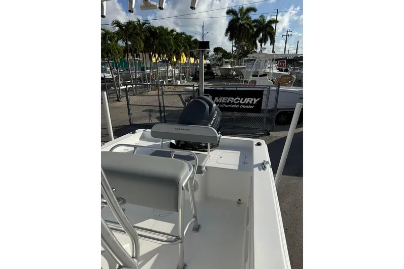Slide: The Image of 2006 Sea Hunt BX22 boat interior with Mercury engine at dealership. - 11