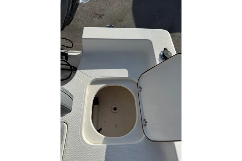 Slide: The Image of Open storage compartment on a 2006 Sea Hunt BX22 boat. - 12
