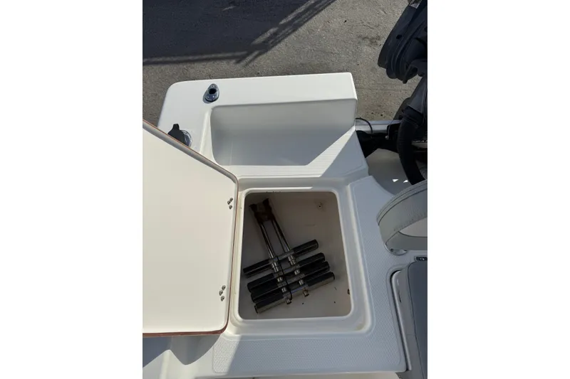 Slide: The Image of Open storage compartment on a 2006 Sea Hunt BX22 boat, showing interior details. - 7