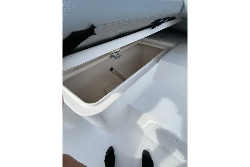 Slide: The Image of Open storage compartment on 2006 Sea Hunt BX22 boat deck. - 22