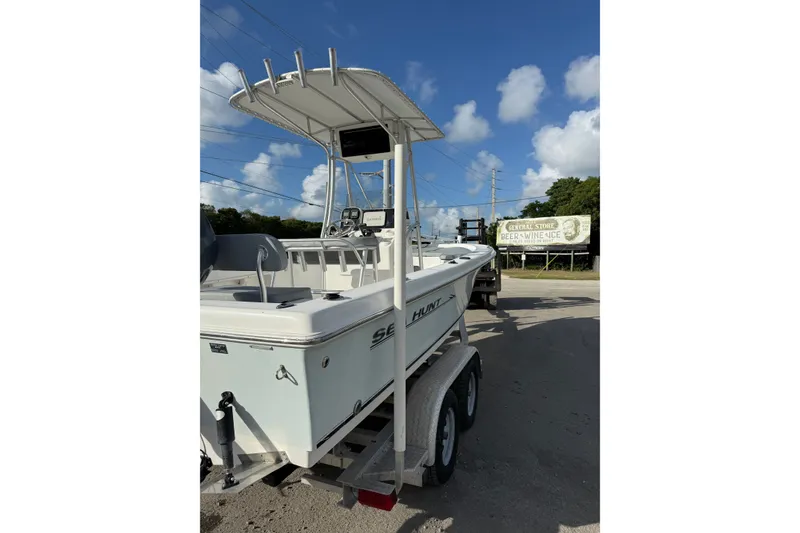 Slide: The Image of 2006 Sea Hunt BX22 boat on trailer under clear blue sky. - 5
