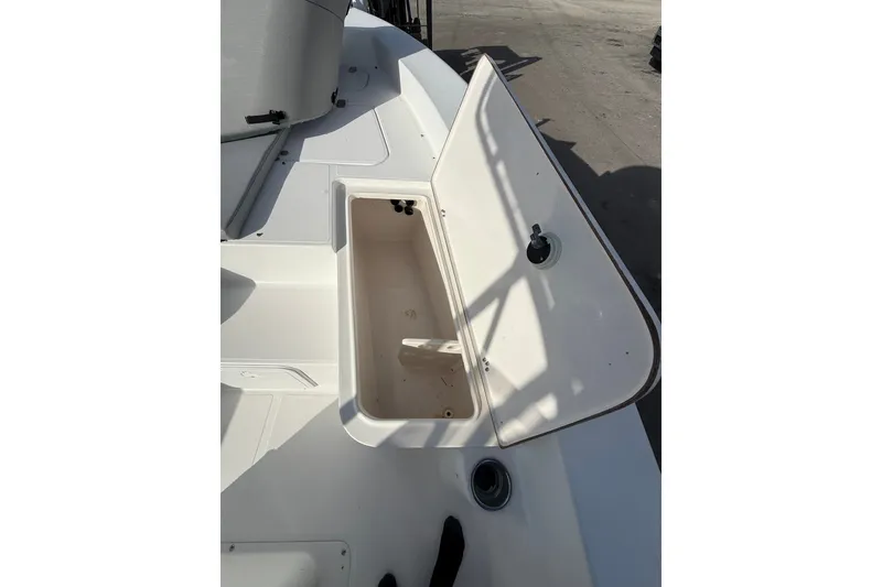 Slide: The Image of Open storage compartment on a 2006 Sea Hunt BX22 boat deck. - 18