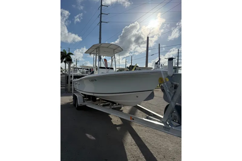 Slide: The Image of 2006 Sea Hunt BX22 boat on trailer under sunny sky. - 3