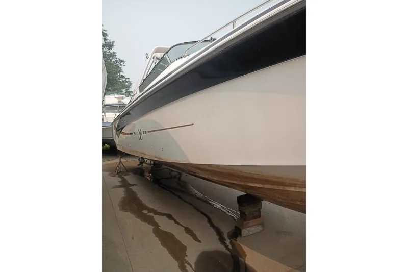 Slide: The Image of 1995 Searay SUNSPORT 38 boat on dry dock, side view showing hull and sleek design. - 3