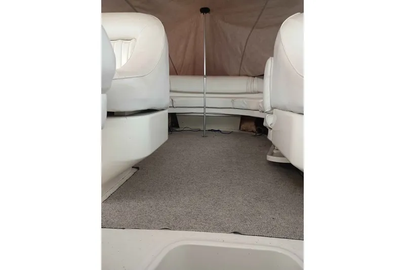 Slide: The Image of Interior view of 1995 Searay SUNSPORT 38 boat with white seating and carpeted floor. - 5