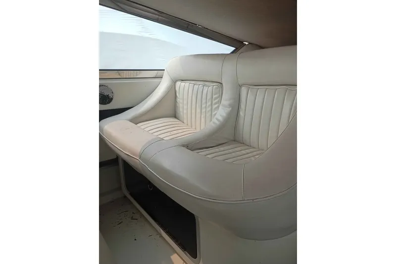 Slide: The Image of Interior seating of a 1995 Searay SUNSPORT 38 boat, featuring white leather upholstery. - 12
