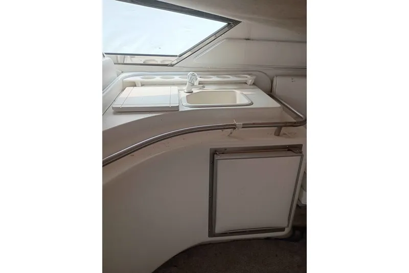 Slide: The Image of 1995 Searay SUNSPORT 38 boat interior with sink and storage area. - 11