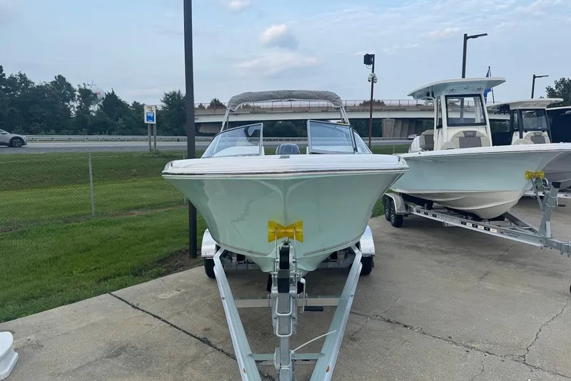 Slide: The Image of 2027 Key West 203 DFS boat on trailer, parked outdoors near highway. - 5