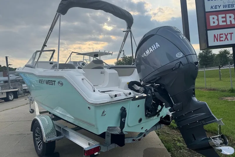 Slide: The Image of 2027 Key West 203 DFS boat with Yamaha engine on trailer, parked outdoors. - 1