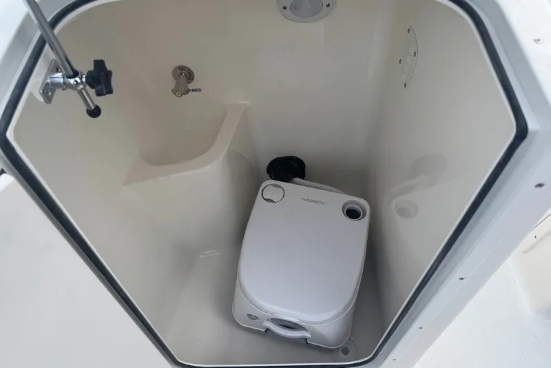 Slide: The Image of 2027 Key West 203 DFS boat interior with compact marine toilet. - 13