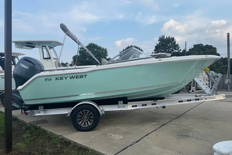 Slide: The Image of 2027 Key West 203 DFS boat on trailer, featuring Yamaha engine, parked outdoors. - 3