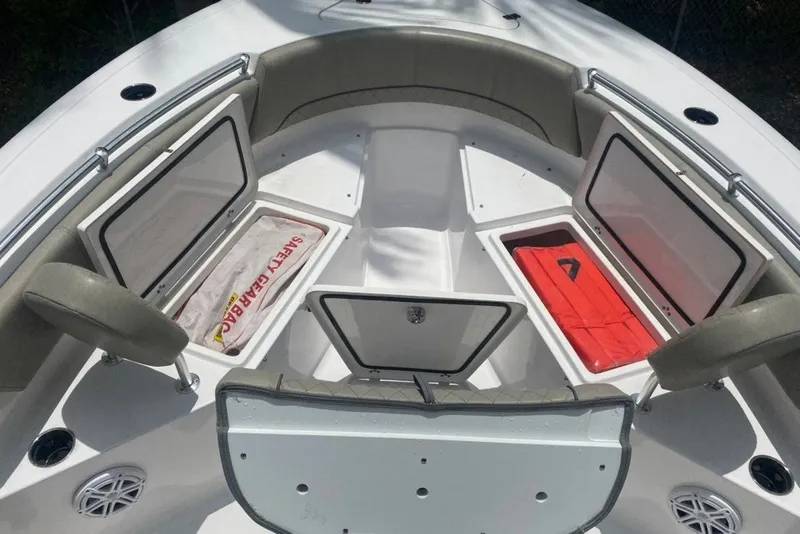 Slide: The Image of 2022 Sportsman Open 232 Center Console boat with open storage compartments and safety gear. - 26