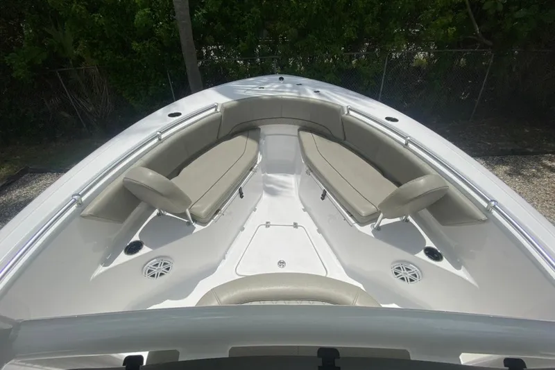 Slide: The Image of 2022 Sportsman Open 232 Center Console boat interior with cushioned seating and speakers. - 20