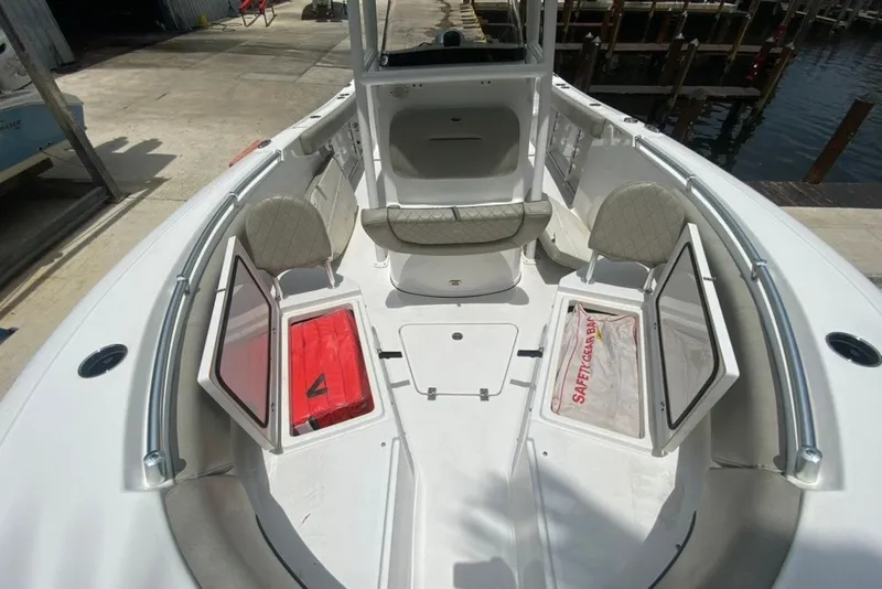Slide: The Image of 2022 Sportsman Open 232 Center Console boat interior with open storage compartments. - 25