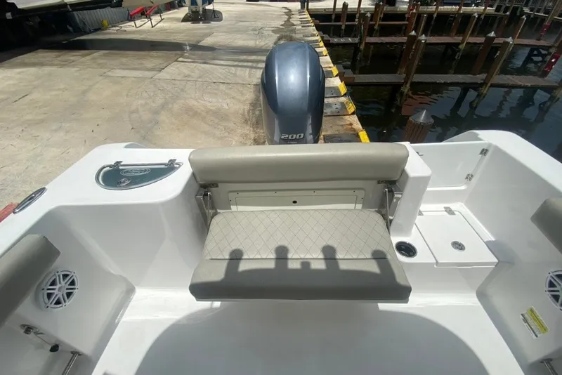 Slide: The Image of 2022 Sportsman Open 232 Center Console boat with cushioned seating and Yamaha 200 engine. - 13