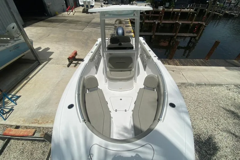 Slide: The Image of 2022 Sportsman Open 232 Center Console boat docked, showcasing spacious seating and sleek design. - 24