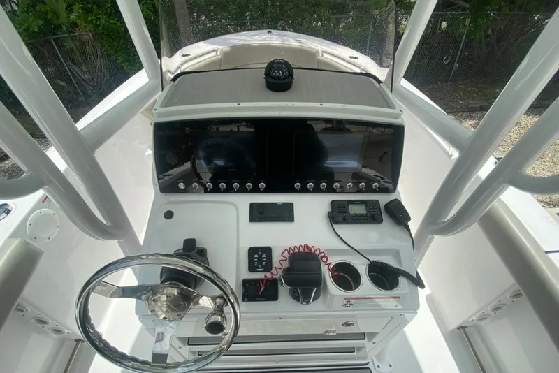 Slide: The Image of 2022 Sportsman Open 232 Center Console dashboard with steering wheel and navigation controls. - 18
