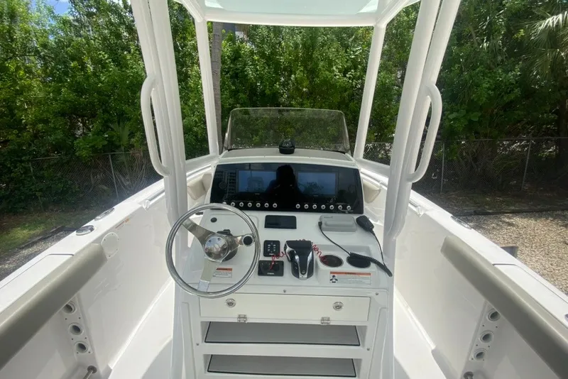 Slide: The Image of 2022 Sportsman Open 232 Center Console boat interior with steering wheel and control panel. - 16