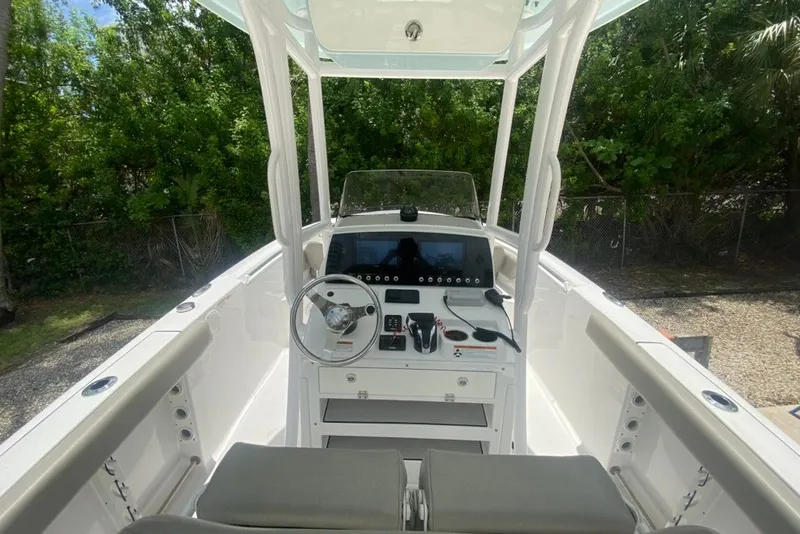 Slide: The Image of 2022 Sportsman Open 232 Center Console boat interior with steering wheel and control panel. - 17