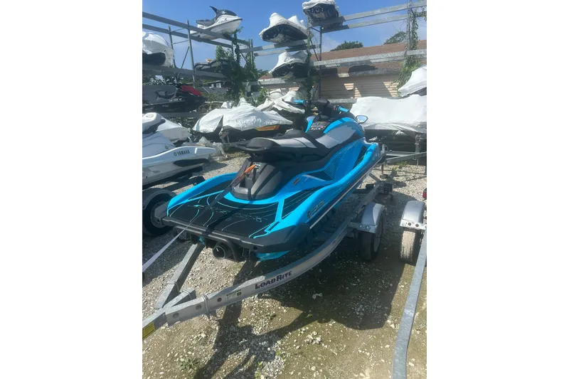 Slide: The Image of 2022 Yamaha WaveRunner GP HO in blue on a trailer, parked outdoors. - 7