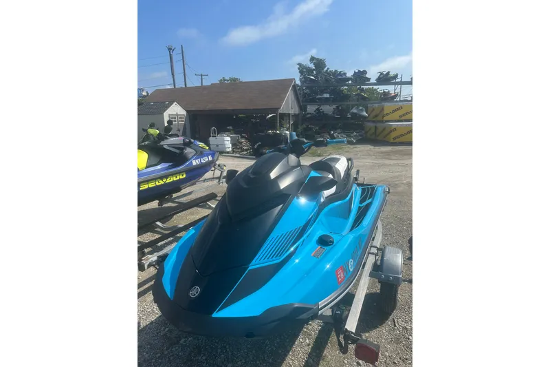 Slide: The Image of 2022 Yamaha WaveRunner GP HO in blue, parked outdoors on a trailer. - 2