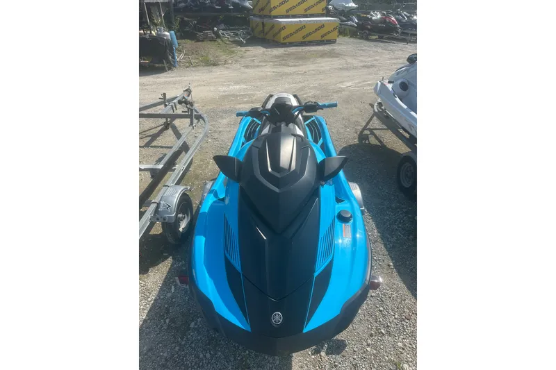 The Image of 2022 Yamaha WaveRunner GP HO in blue, parked on gravel near trailers. - 1