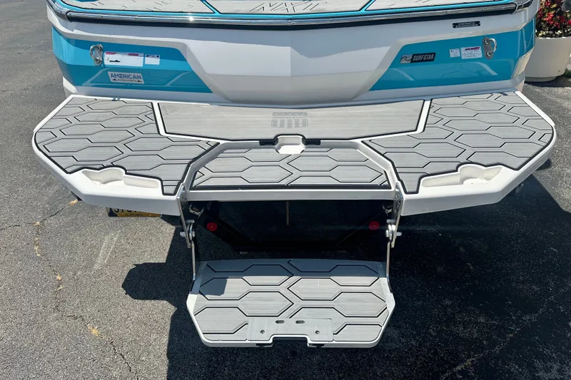 Slide: The Image of 2024 MasterCraft NXT22 boat with hexagonal-patterned swim platform and step ladder. - 5