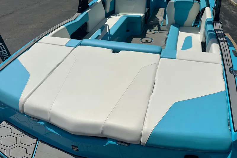 Slide: The Image of 2024 MasterCraft NXT22 boat interior with blue and white seating. - 7
