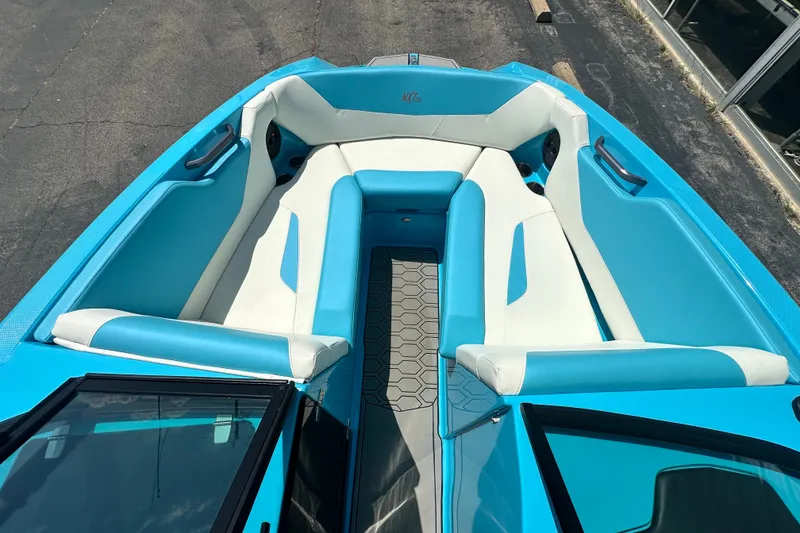 Slide: The Image of 2024 MasterCraft NXT22 boat interior with blue and white seating, showcasing modern design. - 10