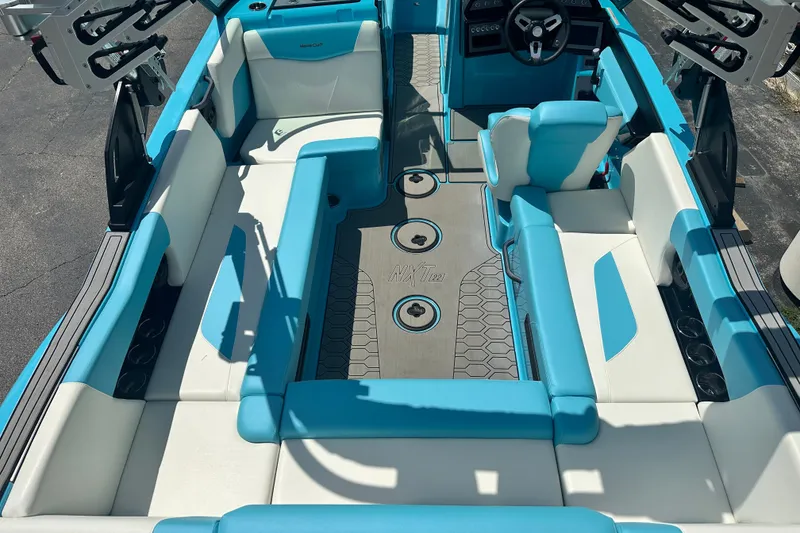 Slide: The Image of 2024 MasterCraft NXT22 boat interior with blue and white seating, modern design. - 8