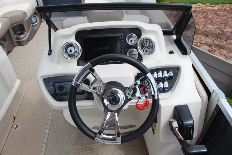Slide: The Image of 2022 Tahoe Pontoon LTZ VRB dashboard with steering wheel and Garmin display. - 14