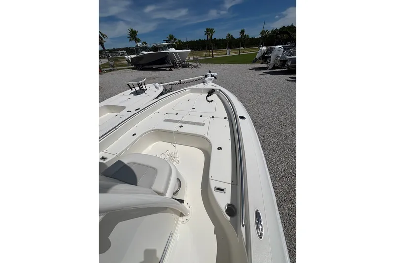Slide: The Image of 2022 ShearWater 250 XTE boat on gravel lot under clear sky. - 4