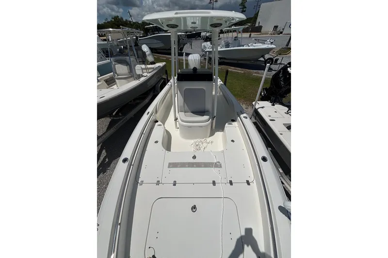 Slide: The Image of 2022 ShearWater 250 XTE boat, white deck, center console, parked outdoors. - 6