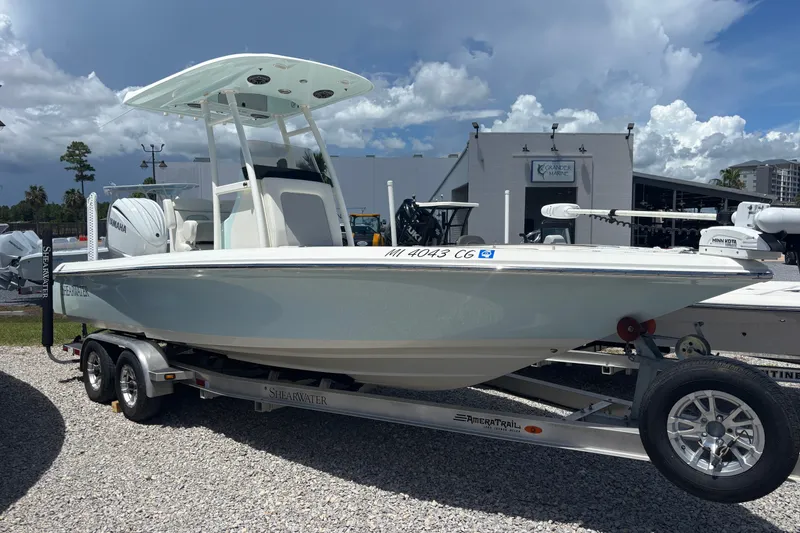 The Image of 2022 ShearWater 250 XTE boat on trailer under cloudy sky. - 1