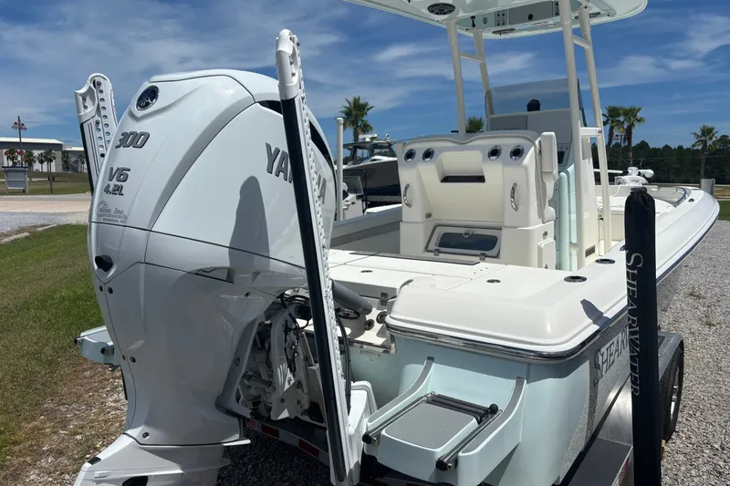 Slide: The Image of 2022 ShearWater 250 XTE boat with Yamaha 300 V6 engine, parked outdoors. - 2